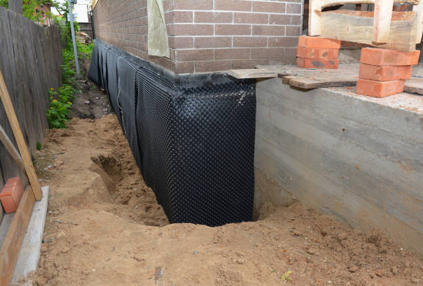 SJ Waterproofing Pros technician performing targeted Waterproofing assessment in Falls Church, VA